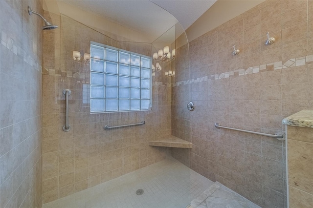 bathroom with lofted ceiling and tiled shower