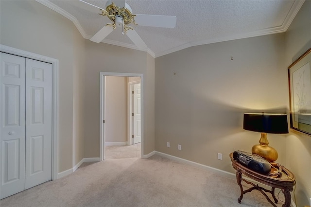 unfurnished bedroom featuring a closet, crown molding, ceiling fan, and light colored carpet