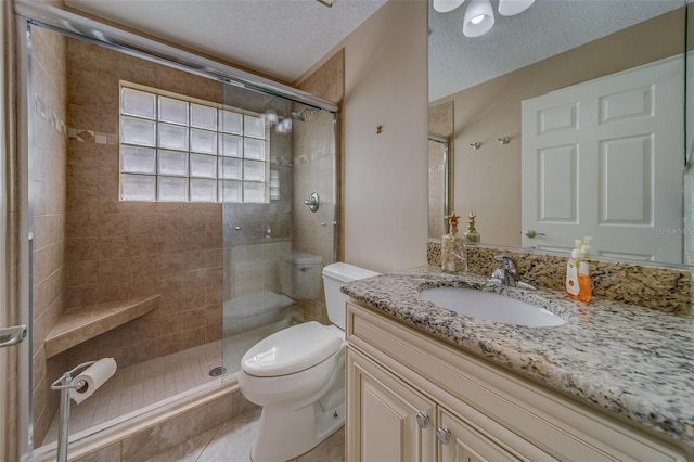 bathroom featuring tile patterned floors, a shower with door, a textured ceiling, and toilet