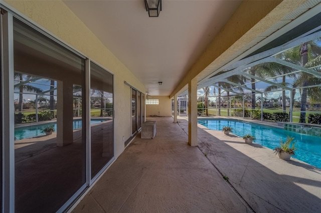 view of pool with a patio area and a lanai