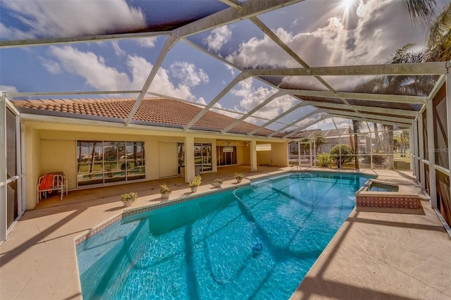 view of swimming pool with glass enclosure, a patio, and a hot tub