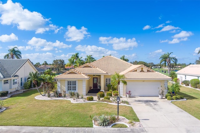 mediterranean / spanish house with a garage and a front lawn