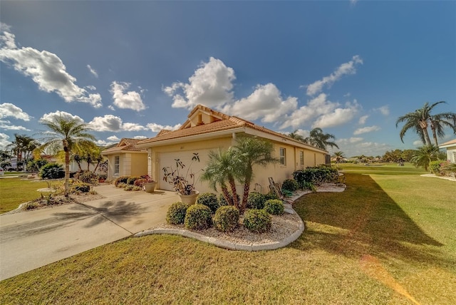 view of front of house with a front yard and a garage