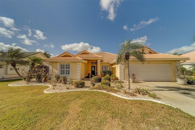 mediterranean / spanish house with a front yard and a garage