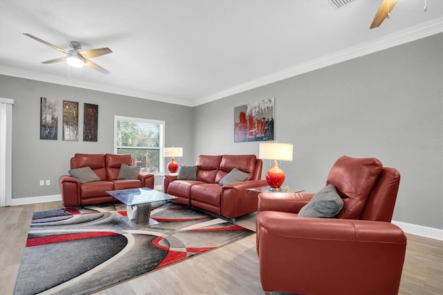 living room with light wood-type flooring, ceiling fan, and crown molding