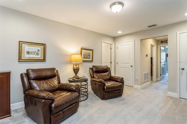 living area with light colored carpet