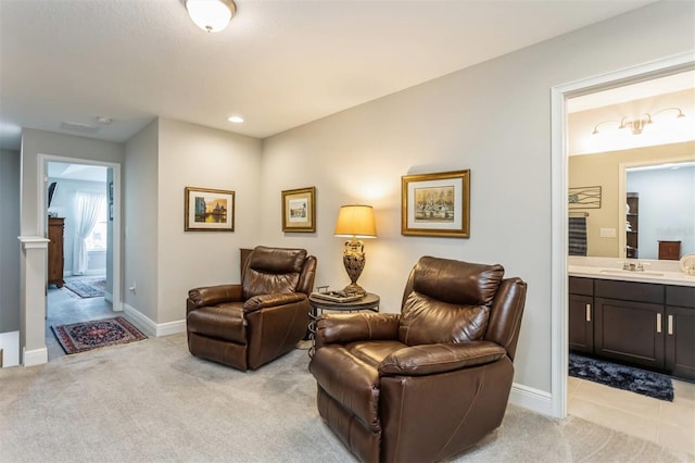 living area with light colored carpet and sink