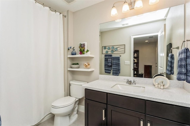 bathroom with tile patterned flooring, vanity, and toilet