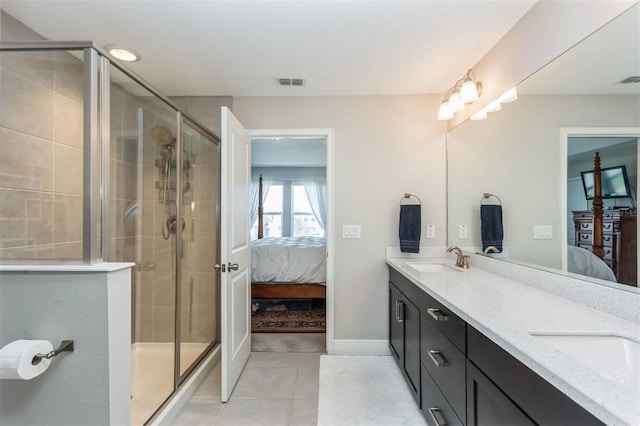 bathroom featuring tile patterned flooring, vanity, and a shower with shower door