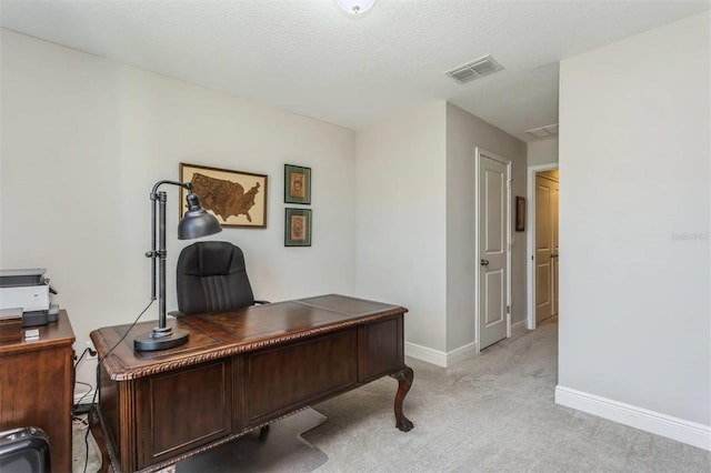 office area featuring light carpet and a textured ceiling