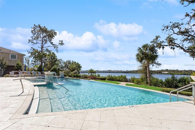 view of swimming pool featuring a patio and a water view