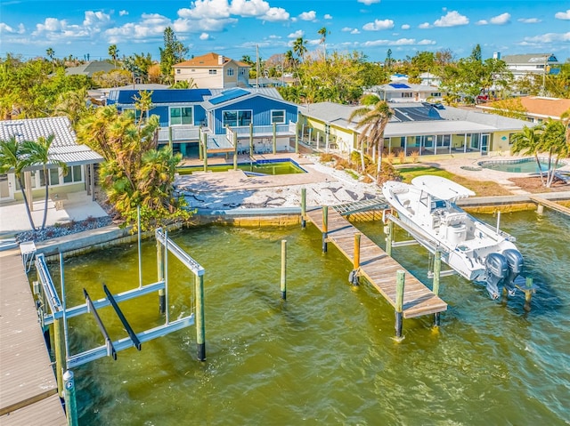 dock area featuring a water view and a patio area