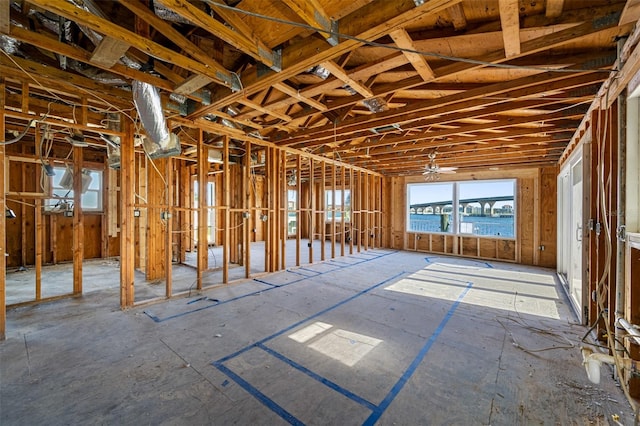 misc room featuring ceiling fan and a water view