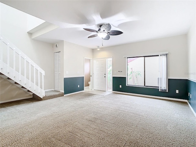 carpeted spare room featuring ceiling fan