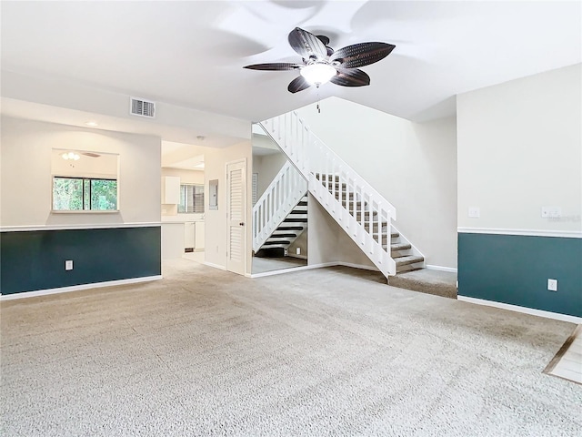 unfurnished living room featuring carpet flooring and ceiling fan