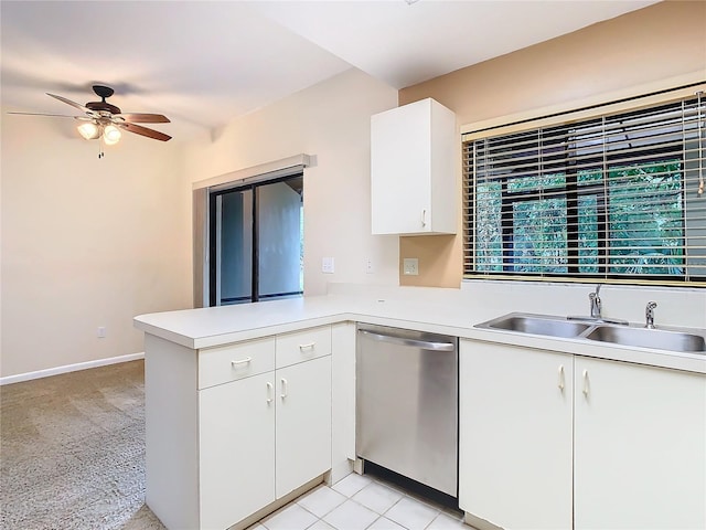 kitchen featuring white cabinets, sink, stainless steel dishwasher, ceiling fan, and light colored carpet