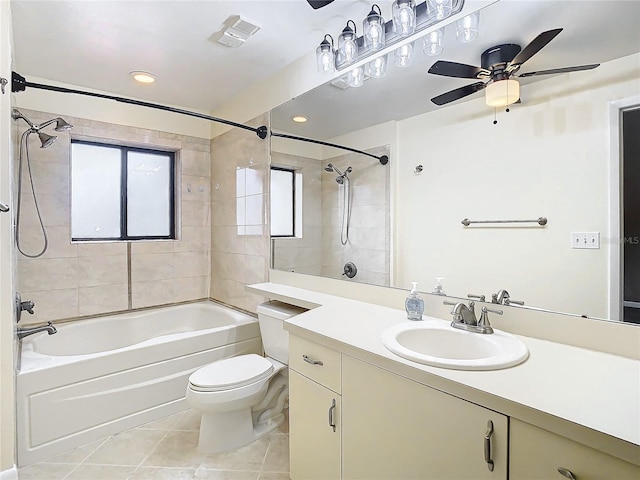 full bathroom with vanity, tile patterned floors, tiled shower / bath, ceiling fan, and toilet