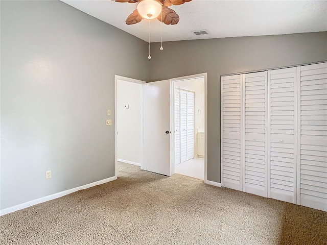 unfurnished bedroom with carpet flooring, ceiling fan, a closet, and vaulted ceiling