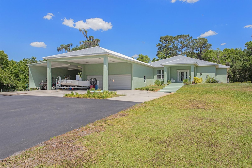 view of front facade with a front yard and a carport