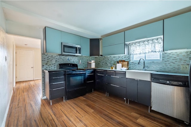 kitchen with dark hardwood / wood-style floors, dishwashing machine, backsplash, and black / electric stove