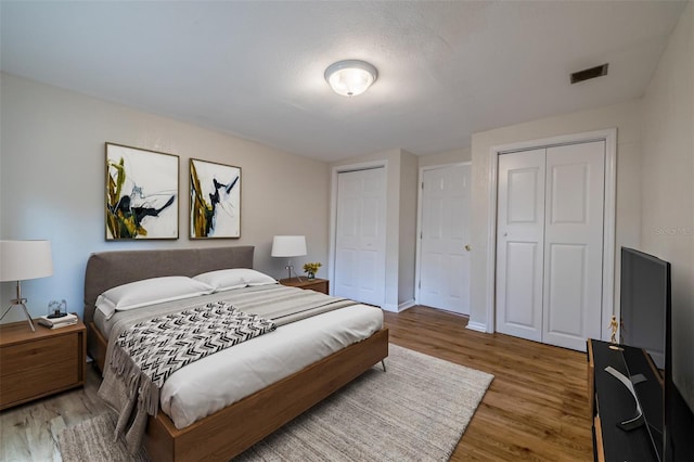 bedroom with a textured ceiling and hardwood / wood-style floors