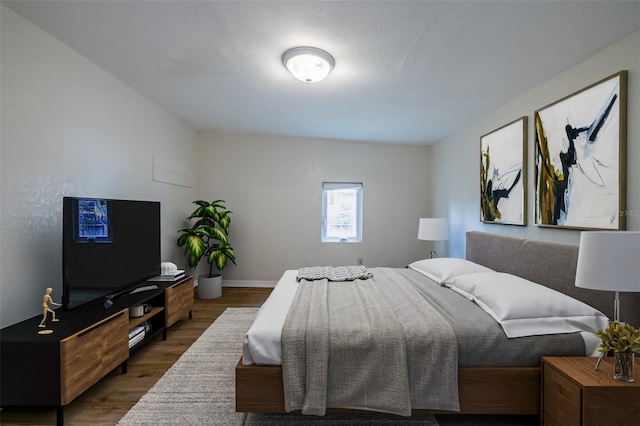 bedroom with dark hardwood / wood-style floors