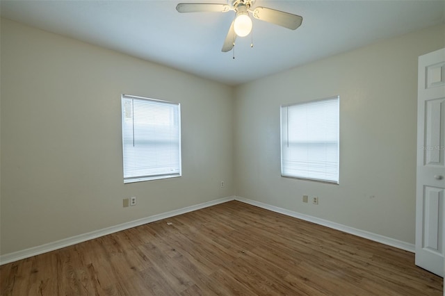 unfurnished room featuring ceiling fan and hardwood / wood-style floors