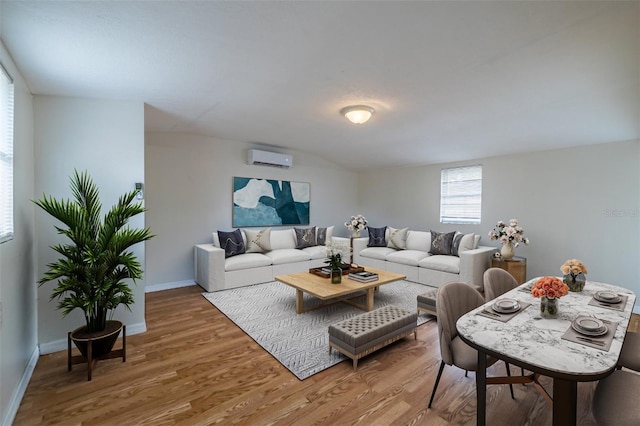 living room with hardwood / wood-style flooring and a wall unit AC