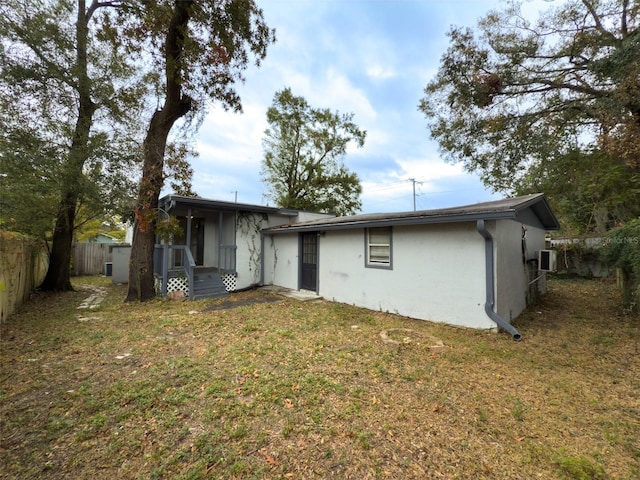 back of property featuring a yard