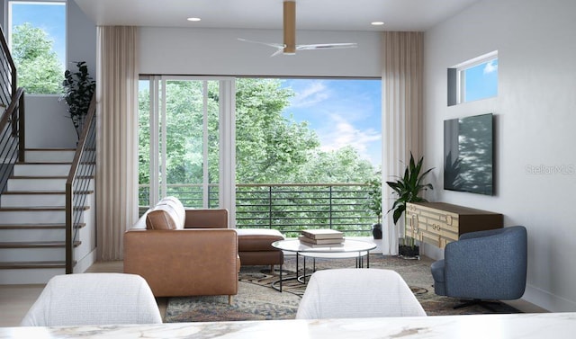 living room featuring ceiling fan and plenty of natural light