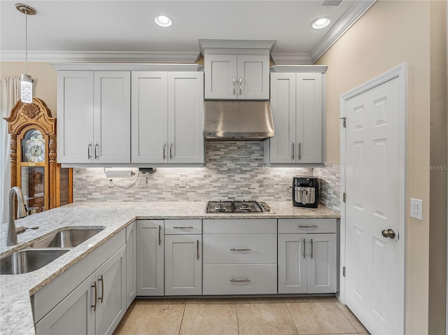 kitchen featuring stainless steel gas stovetop, ornamental molding, sink, and range hood