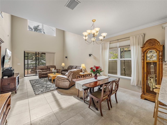 dining space with a chandelier, light tile patterned flooring, a healthy amount of sunlight, and ornamental molding