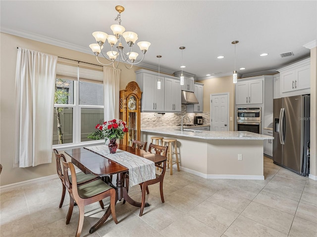 tiled dining space with a notable chandelier, sink, and crown molding