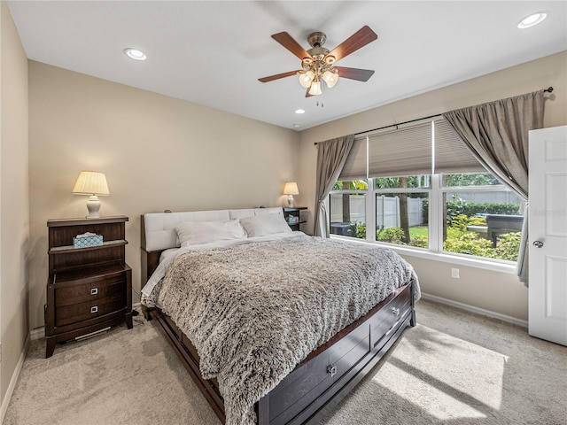 bedroom featuring ceiling fan and light carpet