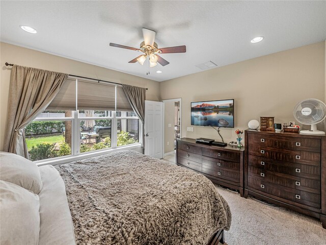 bedroom featuring ceiling fan and light carpet