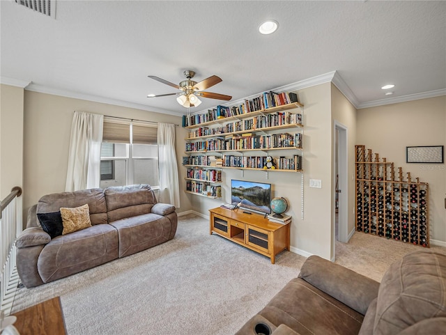 carpeted living room featuring a textured ceiling, ceiling fan, and crown molding