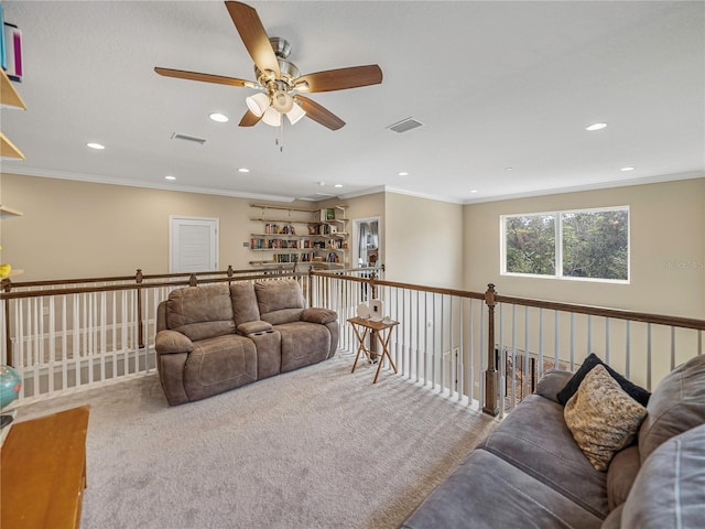 living room with ceiling fan, carpet floors, and ornamental molding