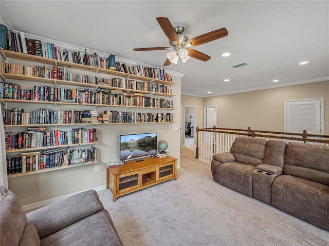 living room with ceiling fan, crown molding, and light carpet