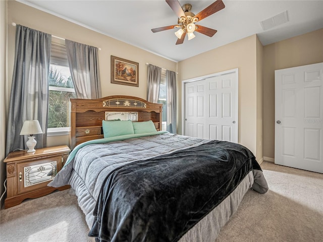 bedroom with light carpet, a closet, and ceiling fan