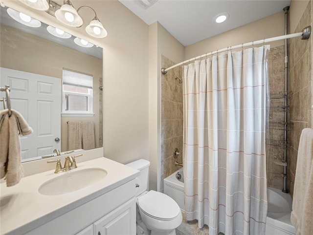 full bathroom featuring shower / bath combo, vanity, and toilet