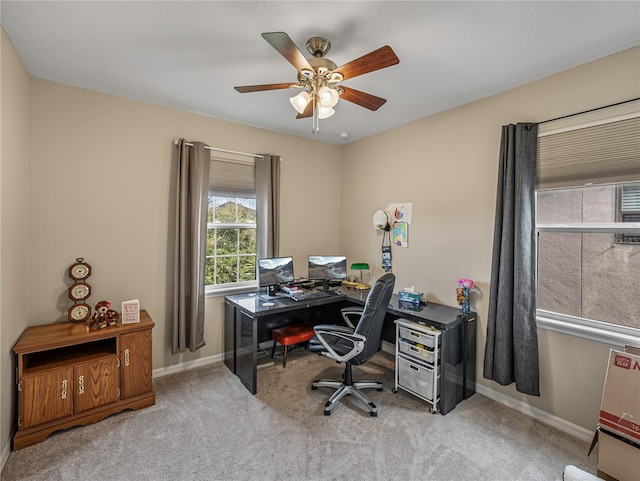 carpeted home office with ceiling fan