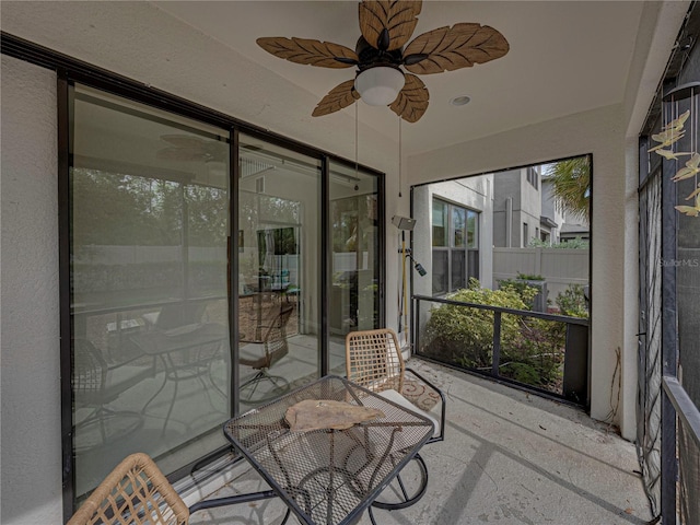 sunroom / solarium featuring ceiling fan