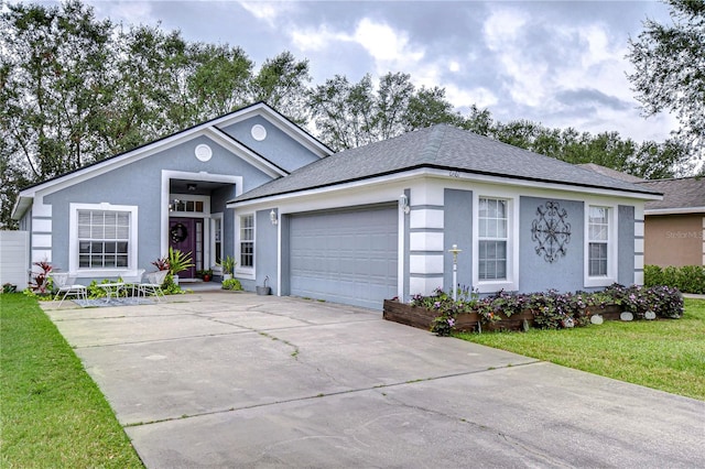 single story home with a garage and a front lawn