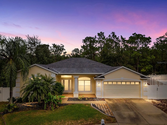 view of front facade featuring a yard and a garage