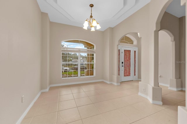 unfurnished room featuring light tile patterned flooring and a chandelier