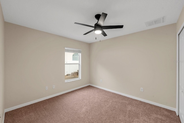 carpeted spare room with ceiling fan