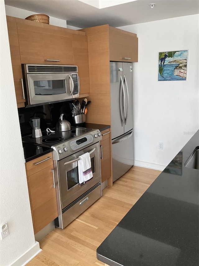 kitchen featuring light hardwood / wood-style floors and appliances with stainless steel finishes