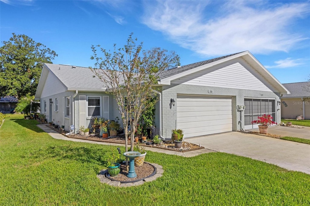 ranch-style house with a garage and a front lawn