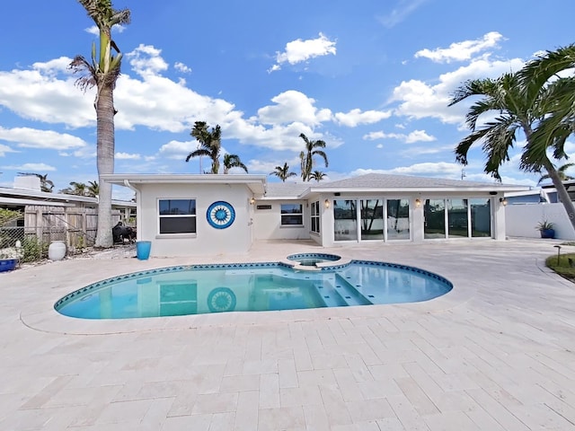 view of swimming pool featuring an in ground hot tub and a patio area