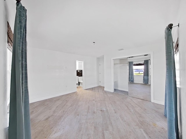 empty room with light hardwood / wood-style flooring